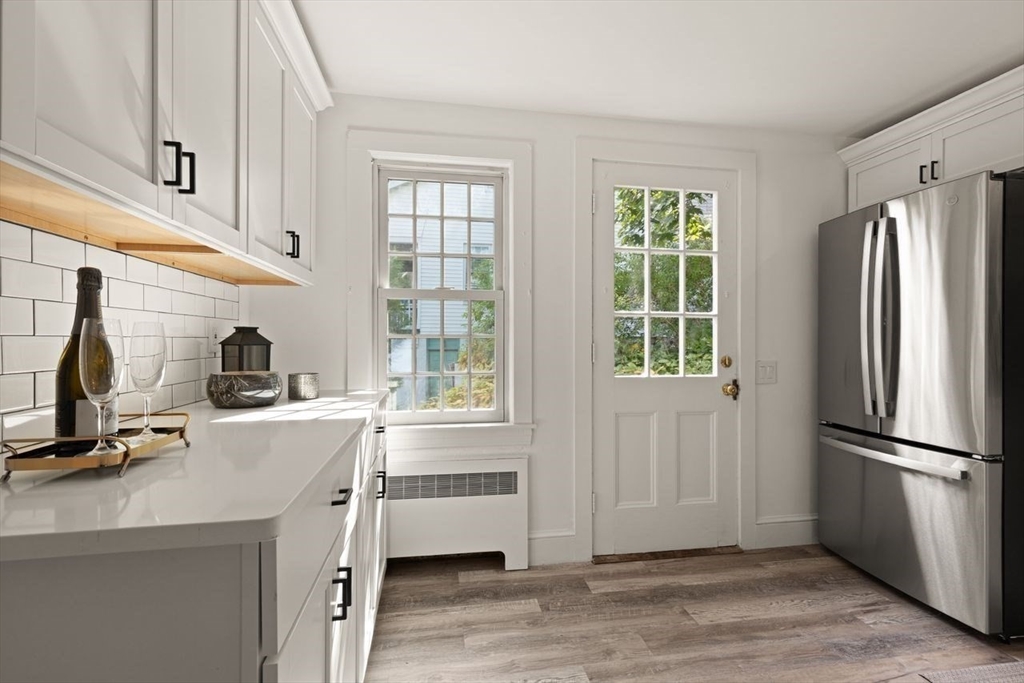 54 Depot Street Sharon, MA 02067 - Photo 16 of 33 a kitchen with a refrigerator a sink and a window
