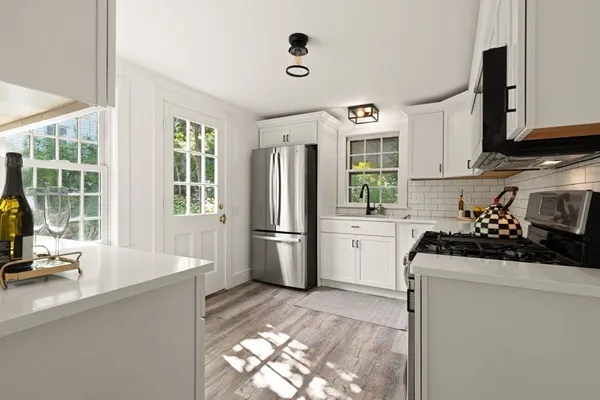 a kitchen with a refrigerator and window
