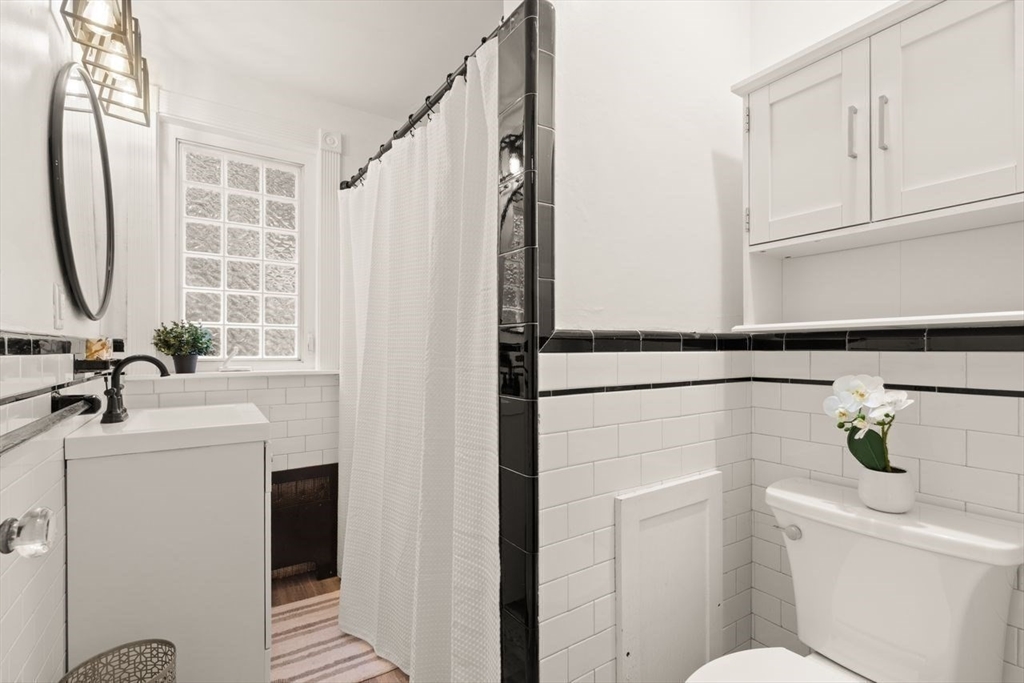 54 Depot Street Sharon, MA 02067 - Photo 22 of 33 a bathroom with a sink a toilet and shower