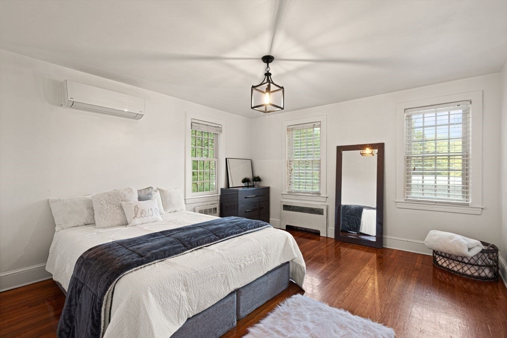 54 Depot Street Sharon, MA 02067 - Photo 6 of 33 a bedroom with a bed and wooden floor