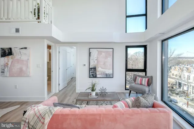 a bedroom with furniture and a large window