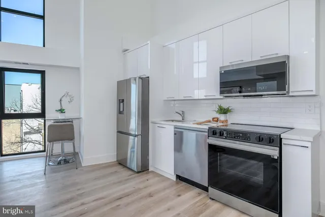 a kitchen with a stove a microwave and a refrigerator