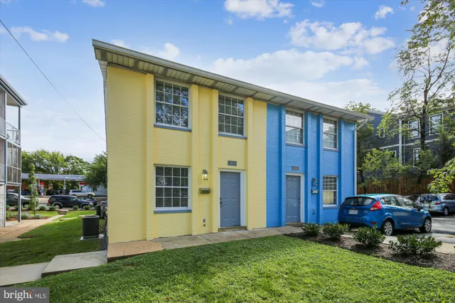 a view of a house with a garden and pathway