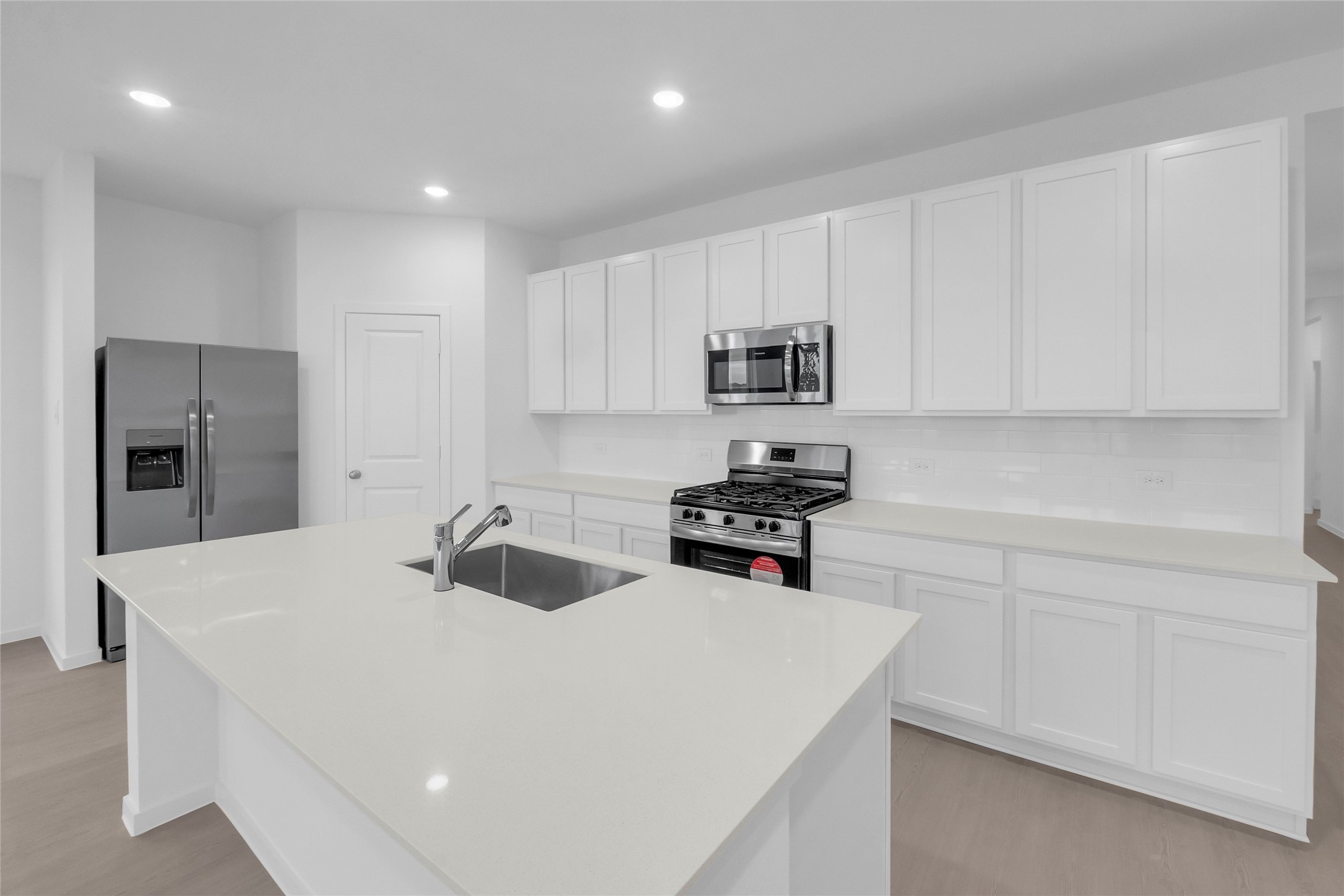 1931 Stargazer Lane Angleton, TX 77515 - Photo 7 of 16 a kitchen with appliances a sink and cabinets