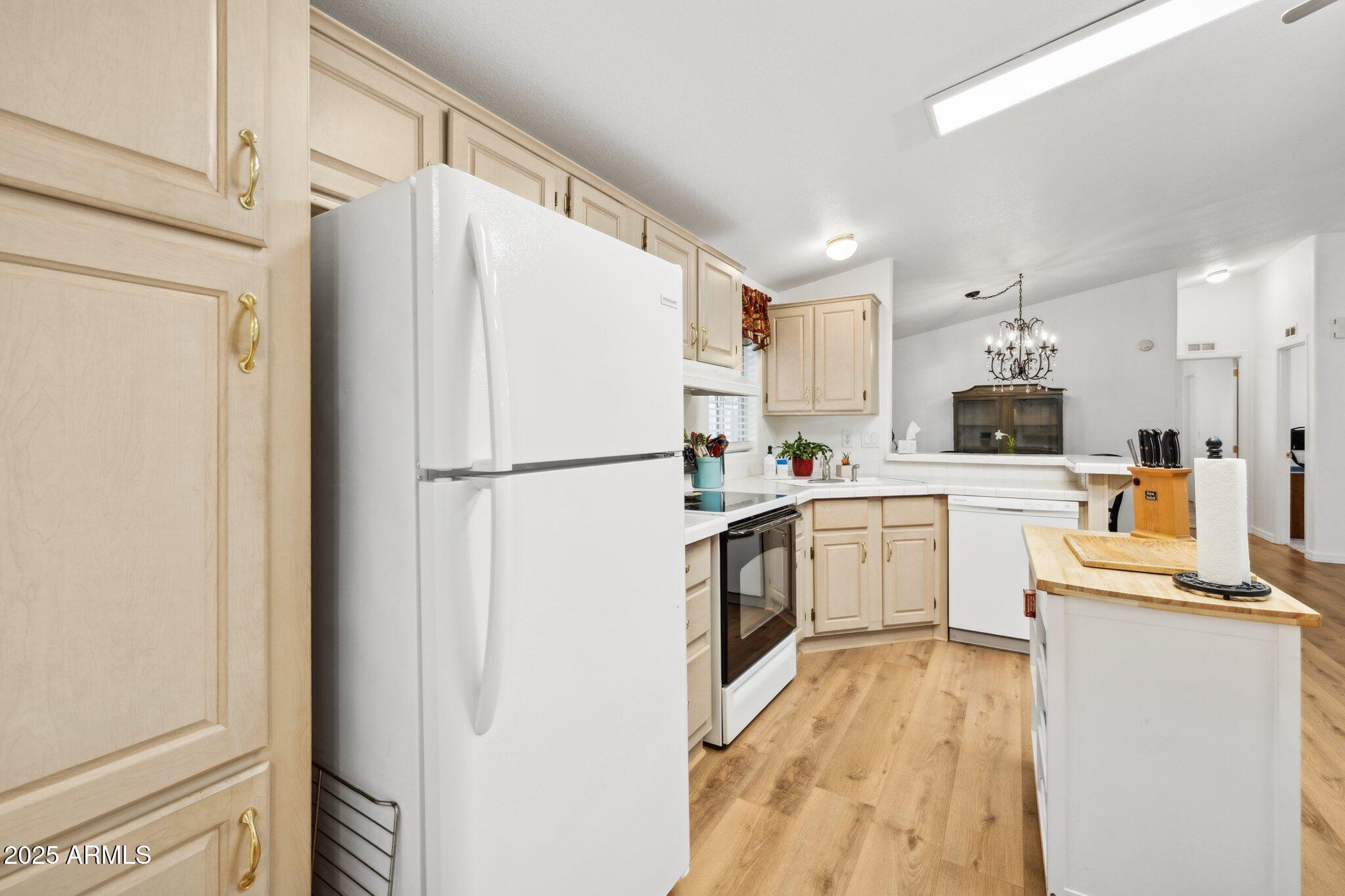 3901 East Pinnacle Peak Road, Unit 105 Phoenix, AZ 85050 - Photo 9 of 23 a kitchen with white cabinets and white appliances