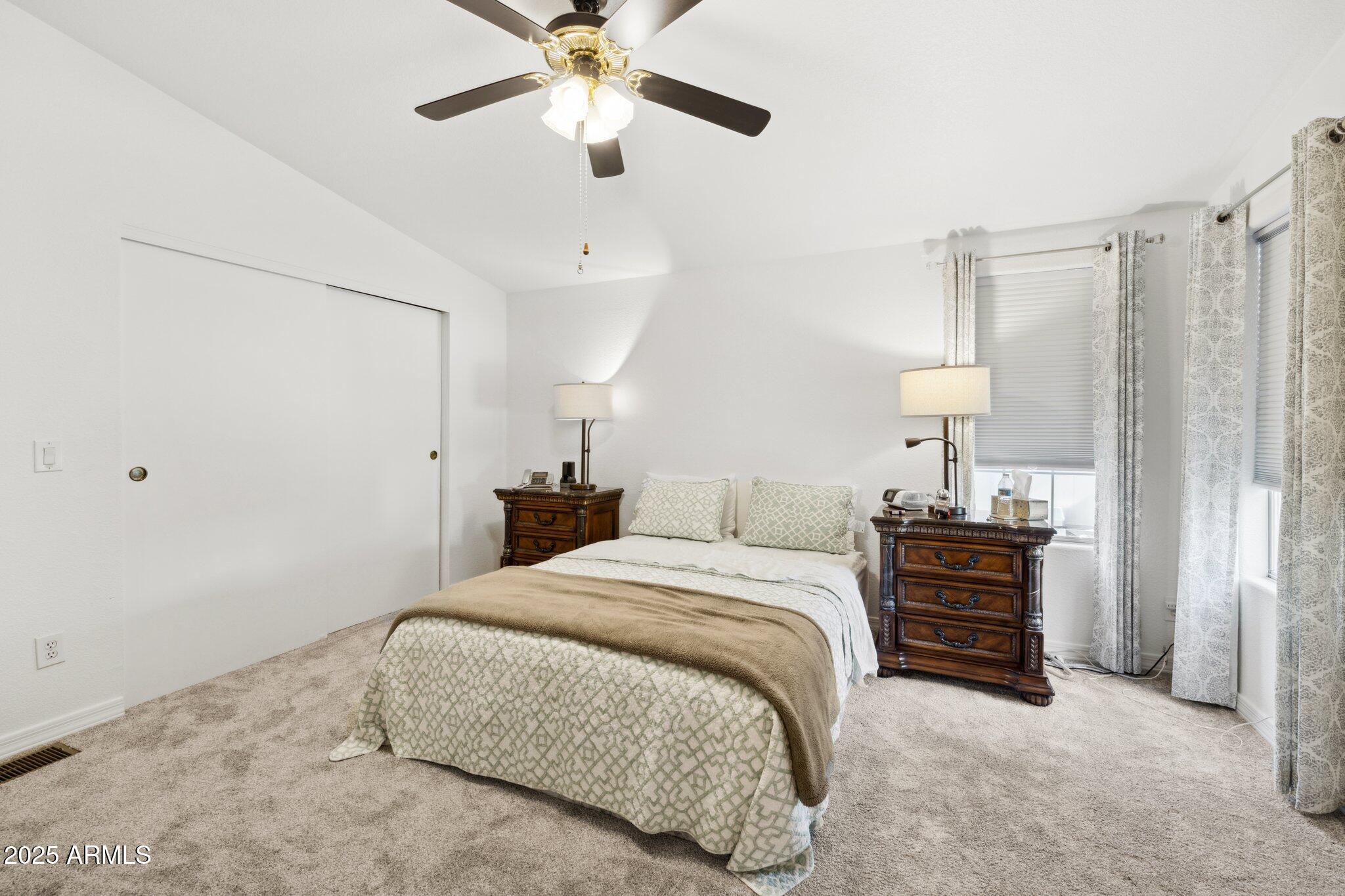 3901 East Pinnacle Peak Road, Unit 105 Phoenix, AZ 85050 - Photo 11 of 23 a bedroom with a bed chandelier and a closet