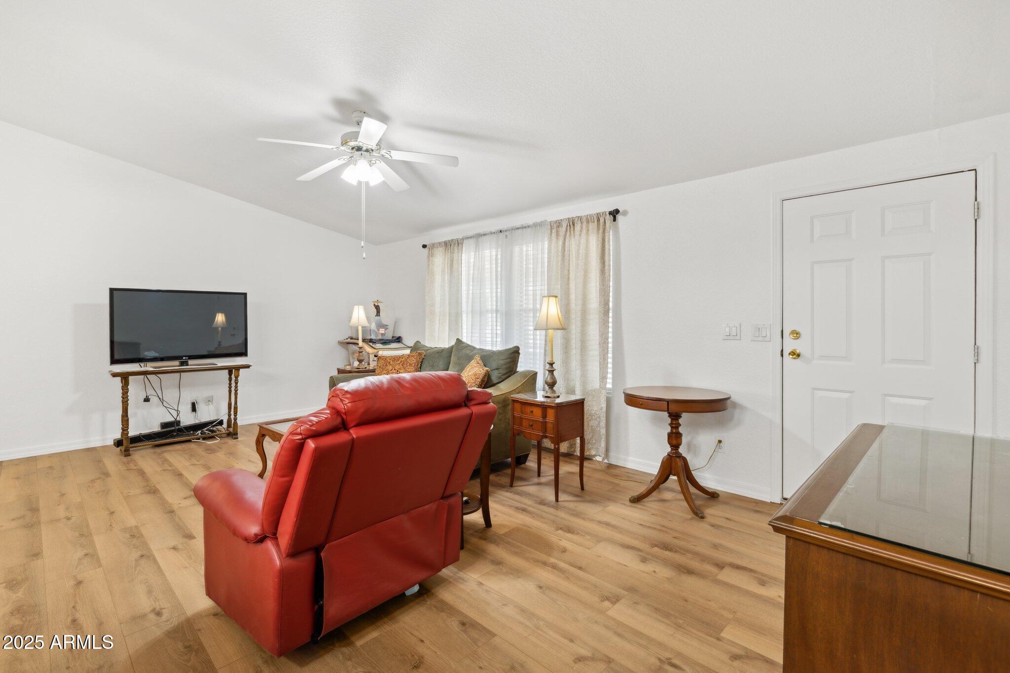 3901 East Pinnacle Peak Road, Unit 105 Phoenix, AZ 85050 - Photo 19 of 23 a living room with furniture and a flat screen tv