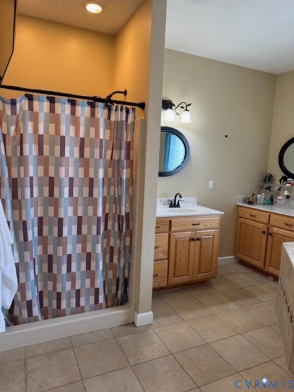 19890 River Road Courtland, VA 23837 - Photo 16 of 32 a bathroom with a double vanity sink and a mirror