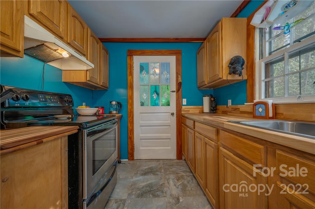 2226 Us Highway Tryon, NC 28782 - Photo 15 of 33 a utility room with stainless steel appliances granite countertop a stove and a sink