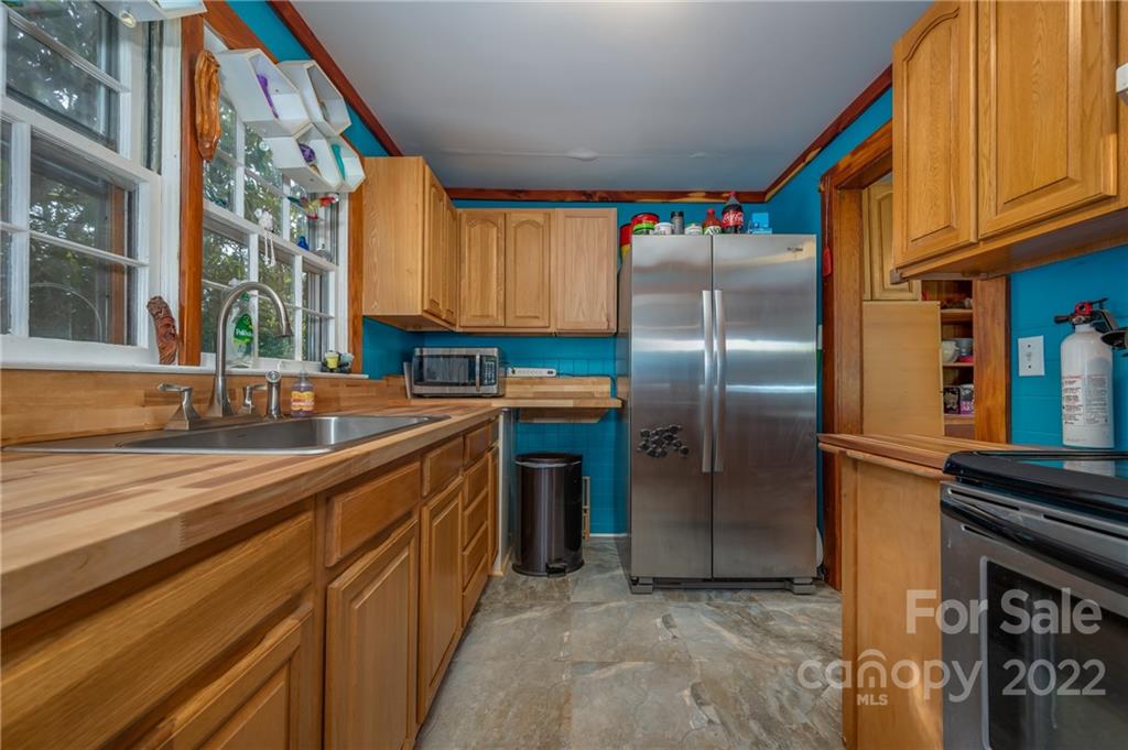 2226 Us Highway Tryon, NC 28782 - Photo 16 of 33 a kitchen with stainless steel appliances granite countertop a refrigerator and a sink