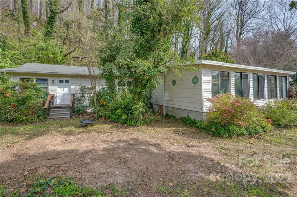 2226 Us Highway Tryon, NC 28782 - Photo 2 of 33 a view of a backyard with plants and large trees