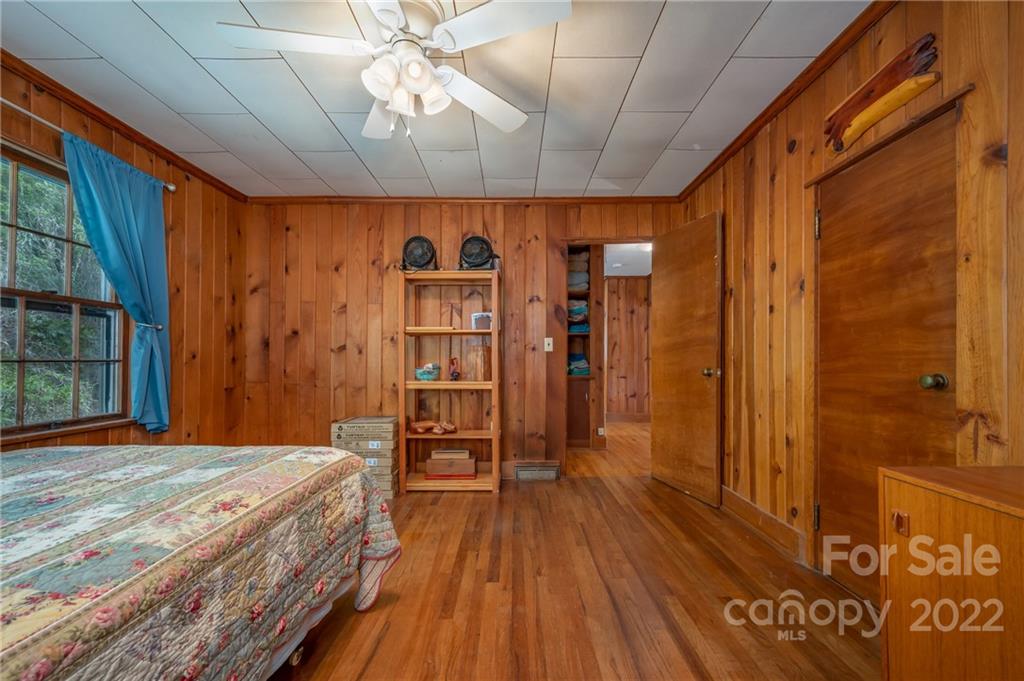 2226 Us Highway Tryon, NC 28782 - Photo 22 of 33 a bedroom with a bed and a wooden floor
