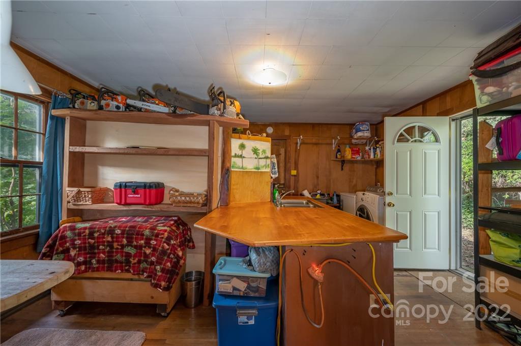 2226 Us Highway Tryon, NC 28782 - Photo 23 of 33 a bedroom with a bed and a flat screen tv