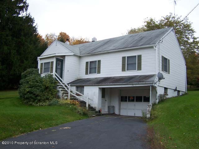 1199 Bendix Road Montrose, PA 18801 - Photo 1 of 7 a front view of a house with a garden