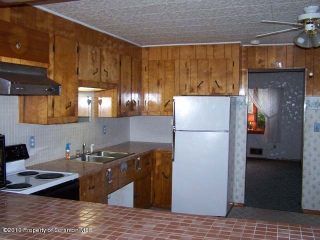 1199 Bendix Road Montrose, PA 18801 - Photo 4 of 7 a kitchen with a refrigerator and a sink