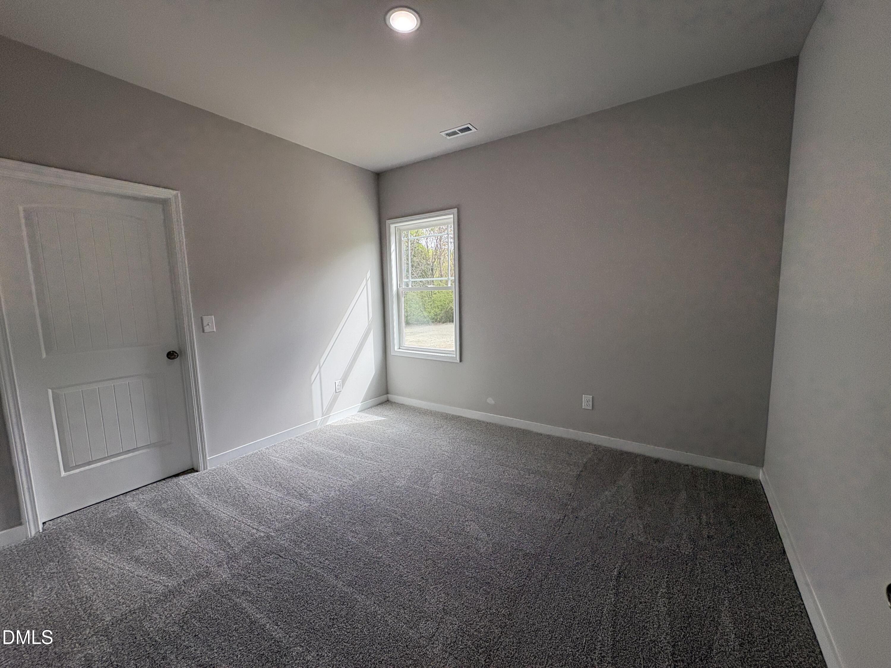 274 Jacobs Ridge Drive Four Oaks, NC 27524 - Photo 11 of 14 a view of an empty room with a window