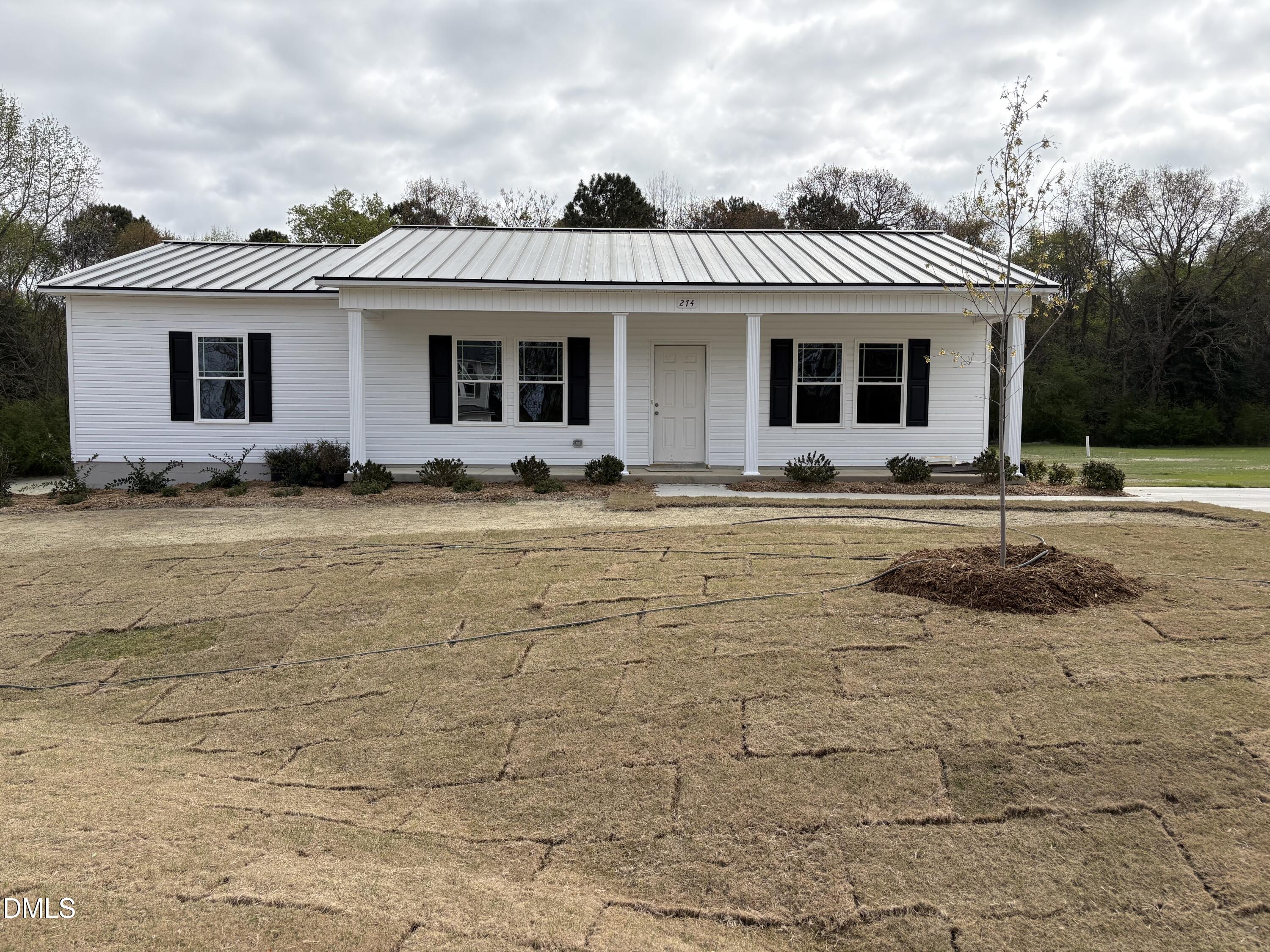 274 Jacobs Ridge Drive Four Oaks, NC 27524 - Photo 2 of 14 a view of a white house with a large windows and a yard