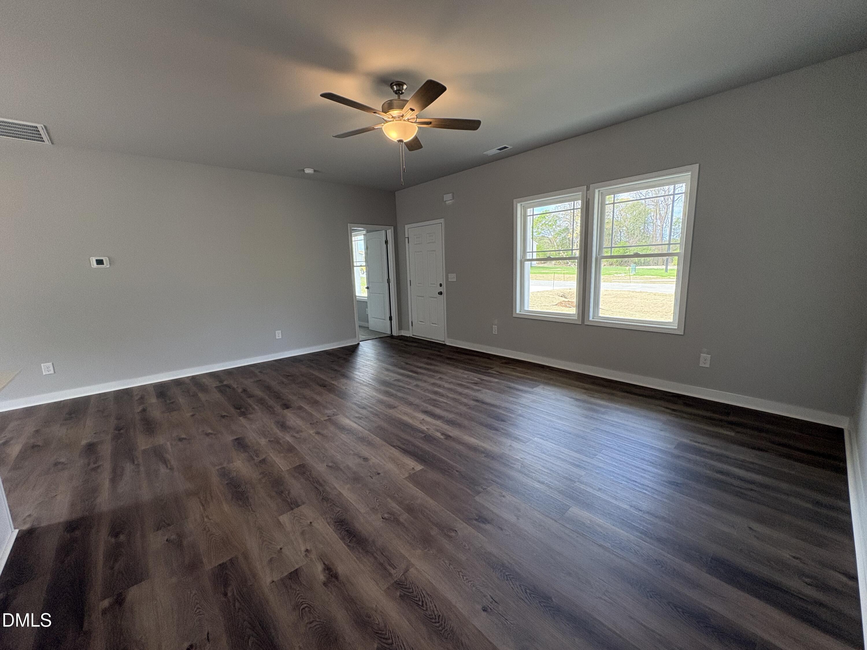 274 Jacobs Ridge Drive Four Oaks, NC 27524 - Photo 4 of 14 a view of an empty room with wooden floor and a window