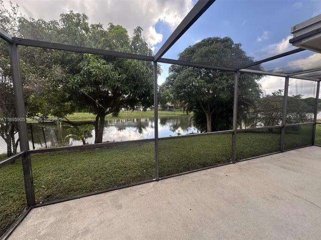 a view of a park with iron fence