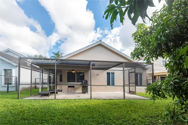a view of a house with a yard and sitting area