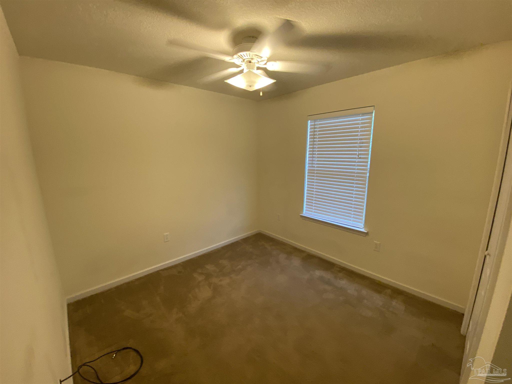 2189 Liberty Loop Road Cantonment, FL 32533 - Photo 11 of 25 a view of a room with a ceiling fan and a window