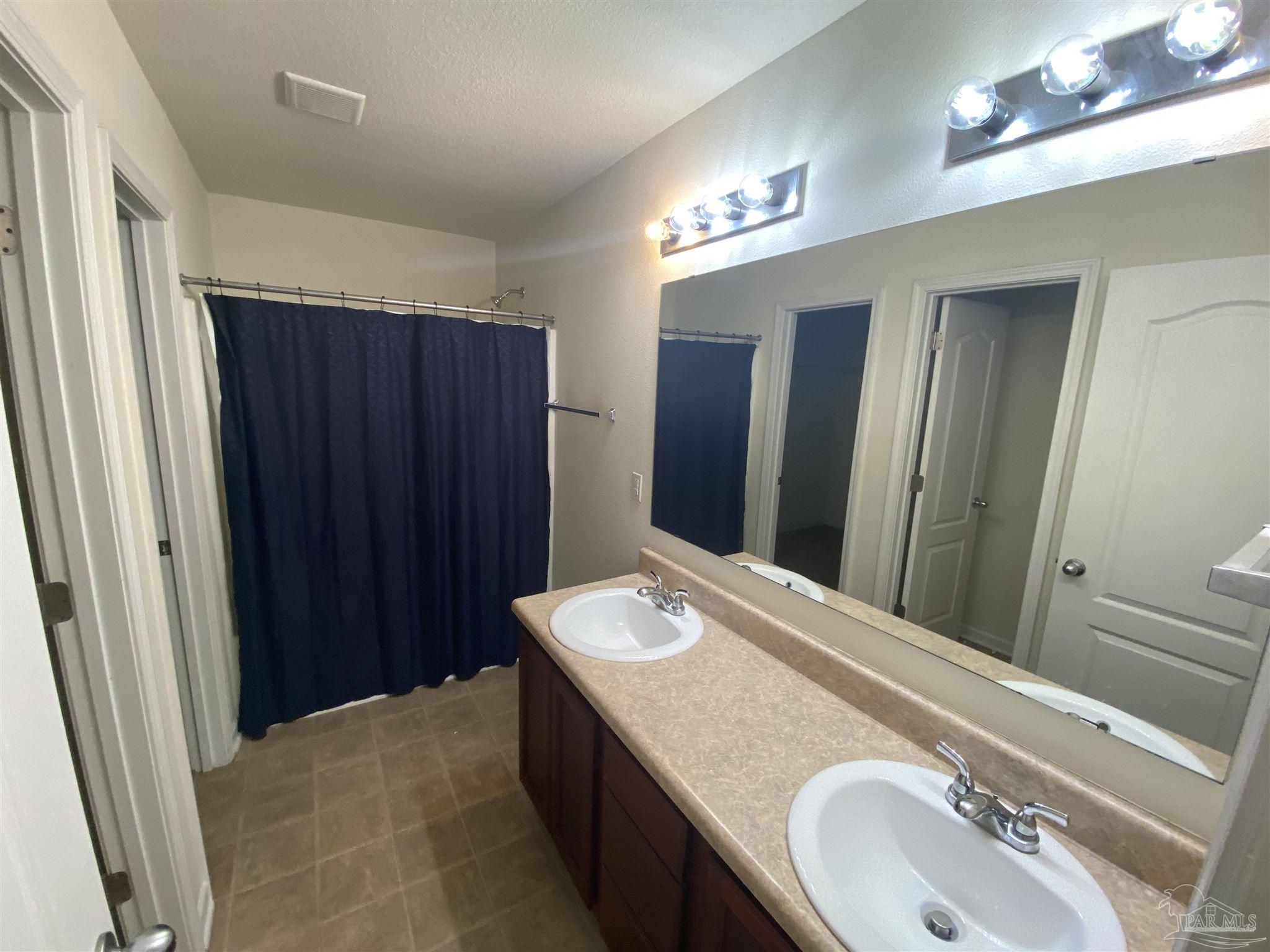2189 Liberty Loop Road Cantonment, FL 32533 - Photo 15 of 25 a bathroom with a sink and a mirror