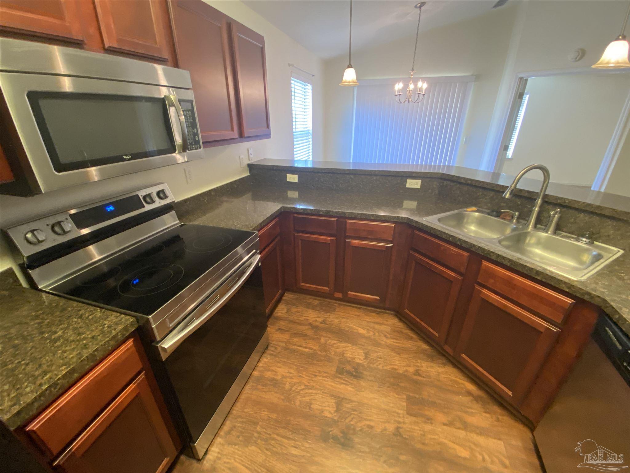 2189 Liberty Loop Road Cantonment, FL 32533 - Photo 18 of 25 a kitchen with a sink and microwave