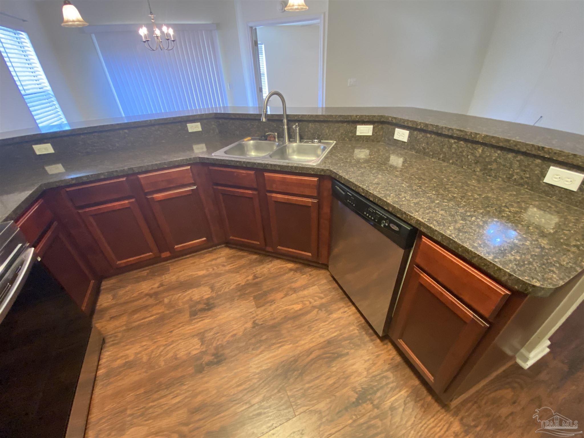 2189 Liberty Loop Road Cantonment, FL 32533 - Photo 19 of 25 a kitchen with a sink and cabinets