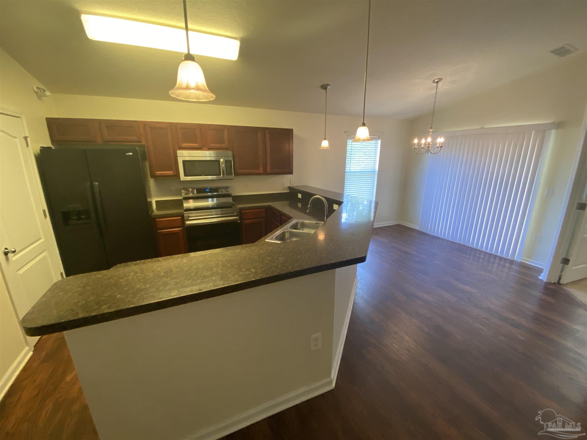 2189 Liberty Loop Road Cantonment, FL 32533 - Photo 21 of 25 a kitchen with counter top space and stainless steel appliances