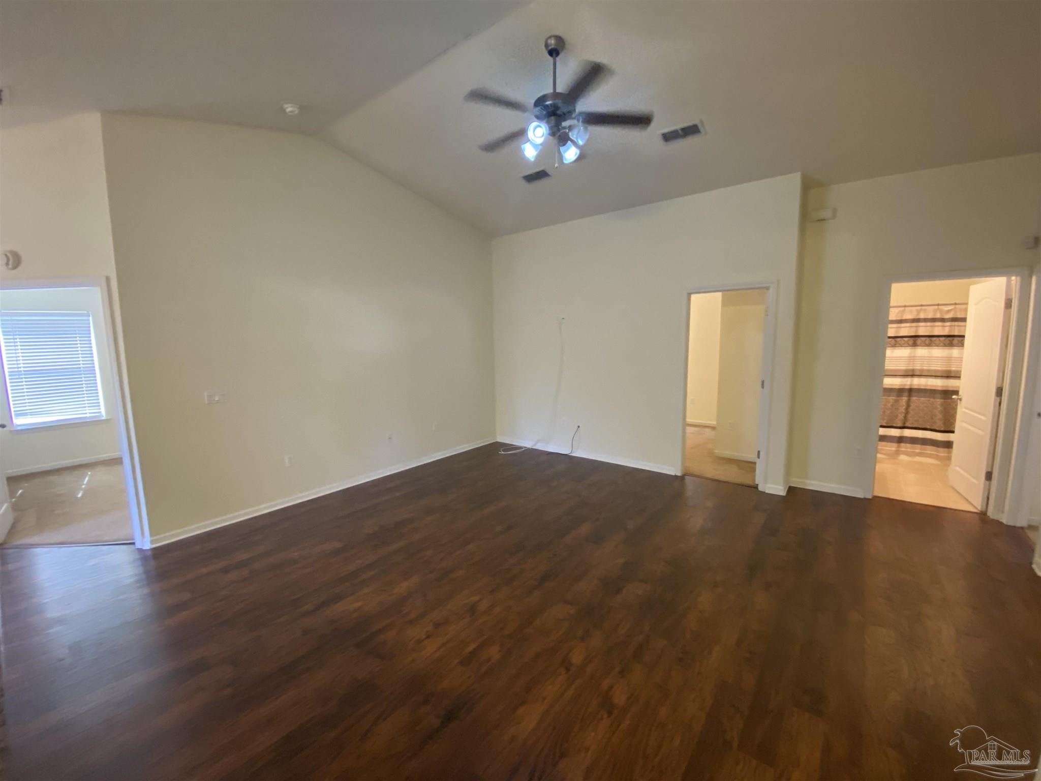 2189 Liberty Loop Road Cantonment, FL 32533 - Photo 22 of 25 a view of an empty room with a window and wooden floor