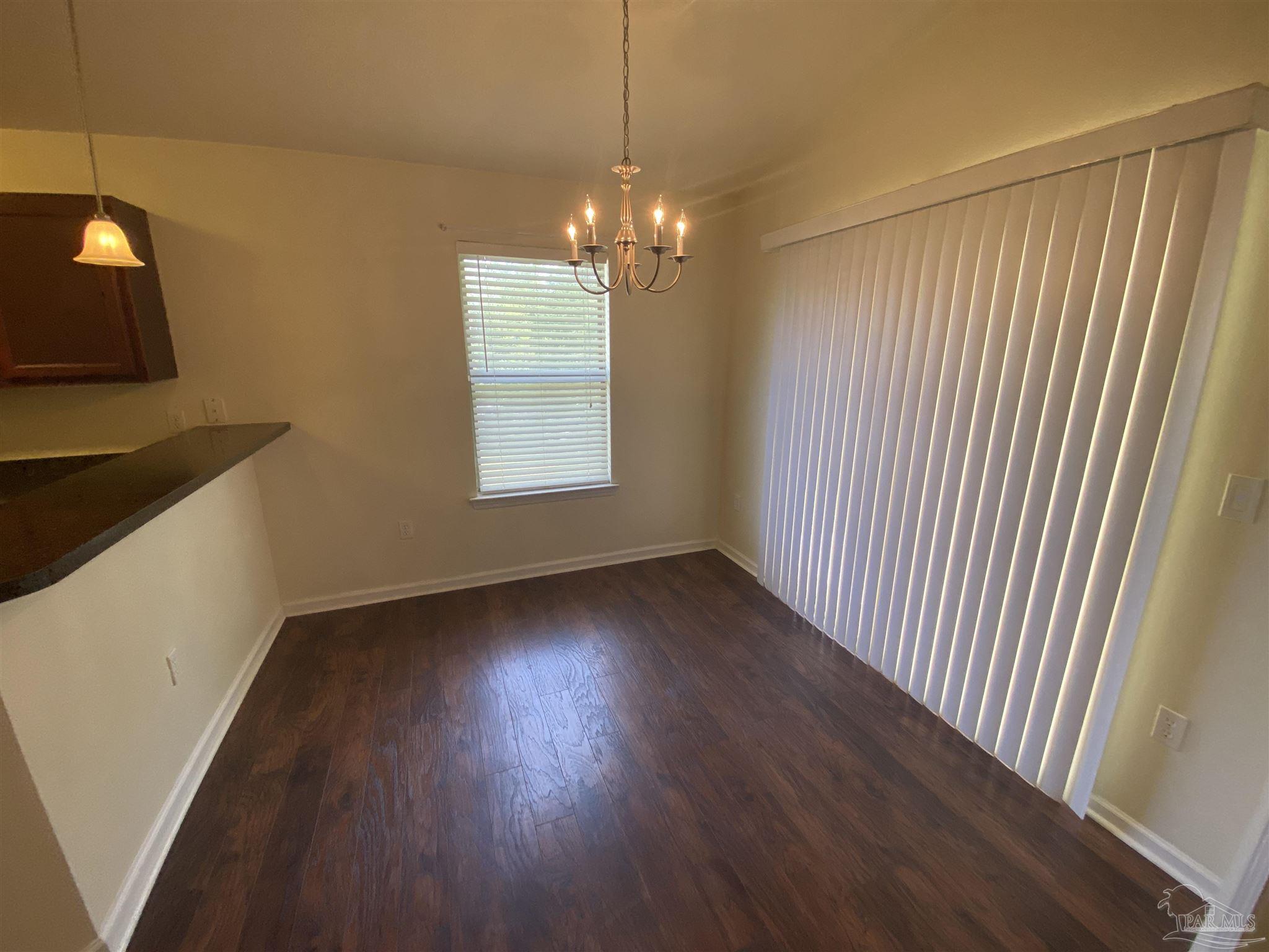 2189 Liberty Loop Road Cantonment, FL 32533 - Photo 24 of 25 a view of an empty room with wooden floor and a window