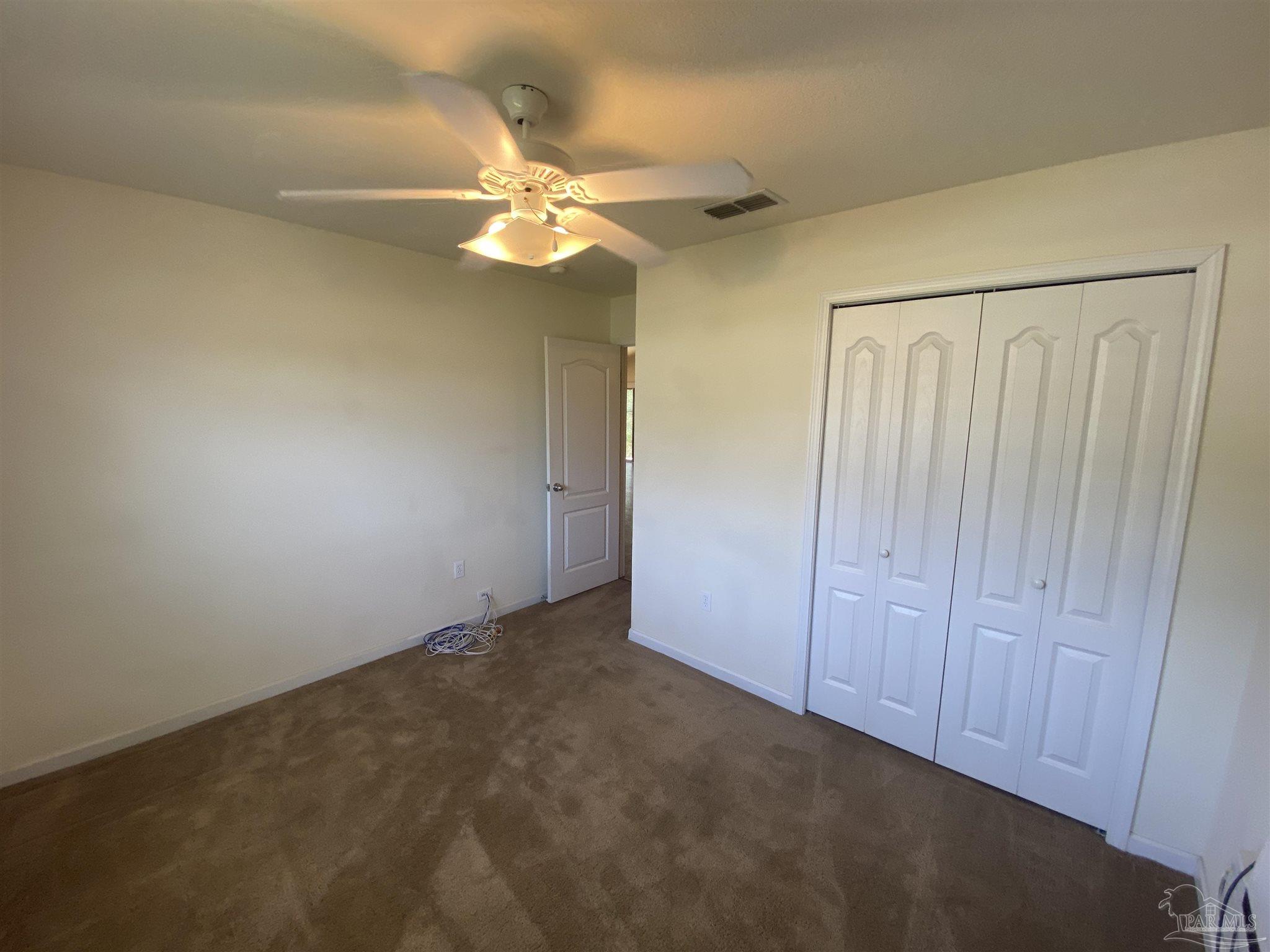 2189 Liberty Loop Road Cantonment, FL 32533 - Photo 9 of 25 an empty room with a chandelier fan