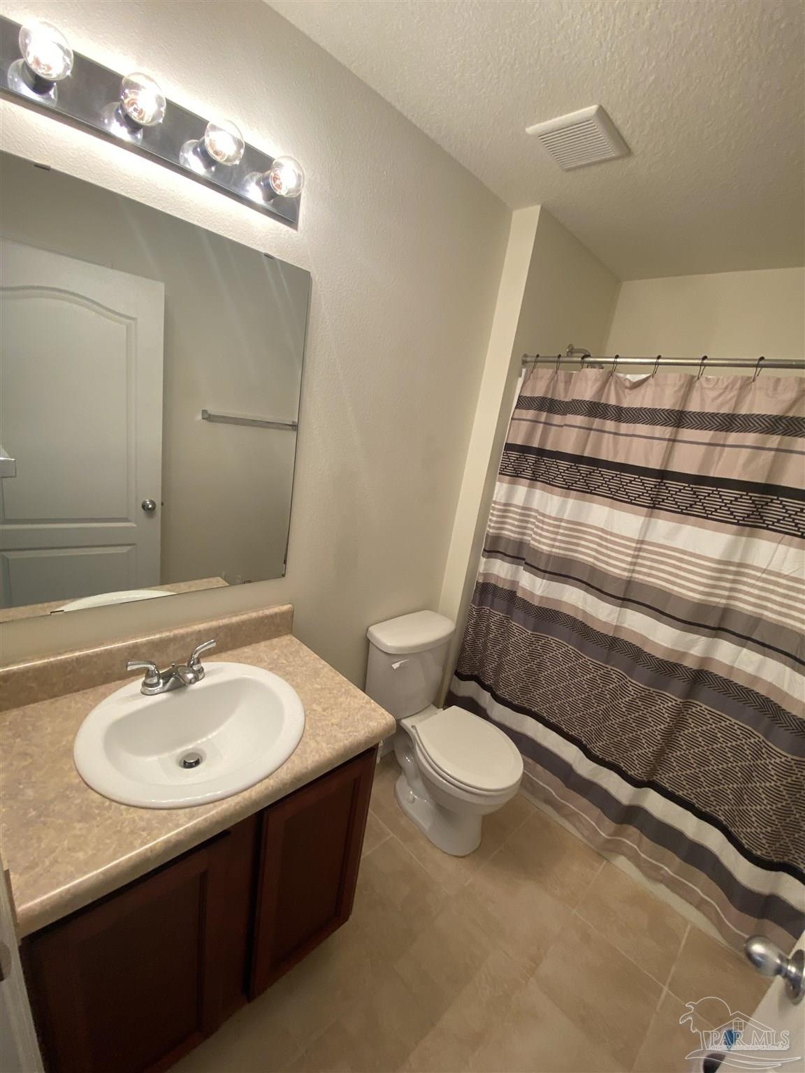 2189 Liberty Loop Road Cantonment, FL 32533 - Photo 10 of 25 a bathroom with a sink toilet and a mirror