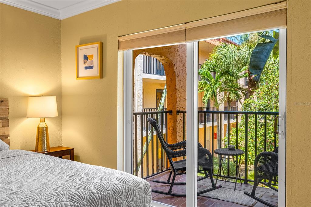 8911 Blind Pass Road, Unit 223 St. Pete Beach, FL 33706 - Photo 20 of 29 a bedroom with a bed and a window