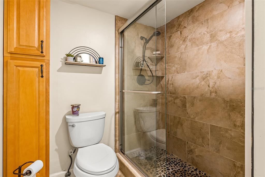 8911 Blind Pass Road, Unit 223 St. Pete Beach, FL 33706 - Photo 21 of 29 a white toilet sitting next to a bathroom sink