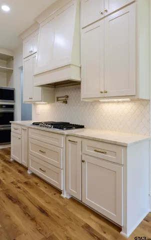 a kitchen with granite countertop cabinets and white appliances