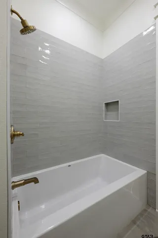 a bathroom with a bathtub and shower