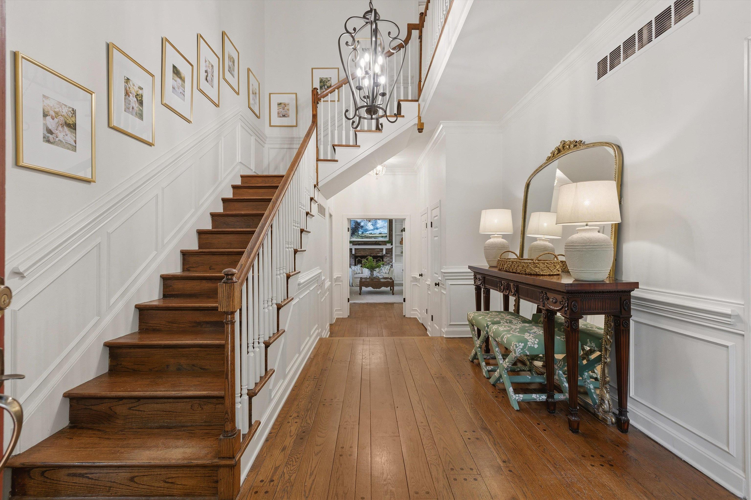 5828 Haymarket Road Memphis, TN 38120 - Photo 7 of 40 Grand foyer featuring wood-finish flooring and a staircase with wood treads and white risers