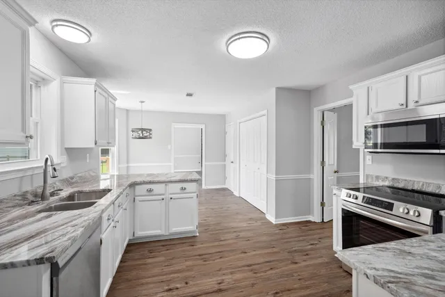 a large kitchen with a stove top oven and refrigerator