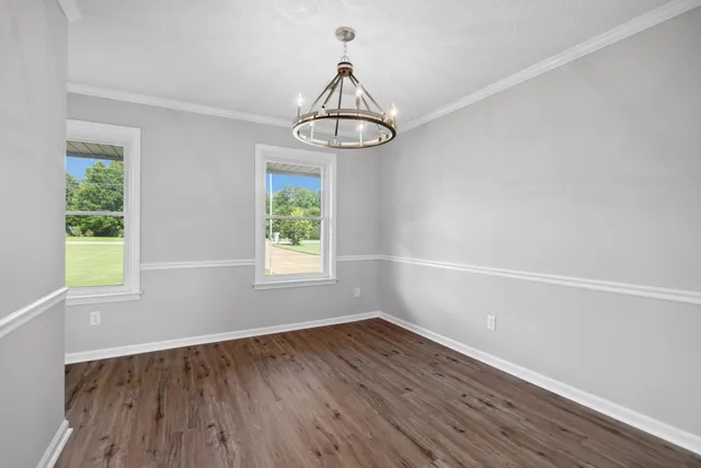 a view of a room with wooden floor window and a ceiling fan