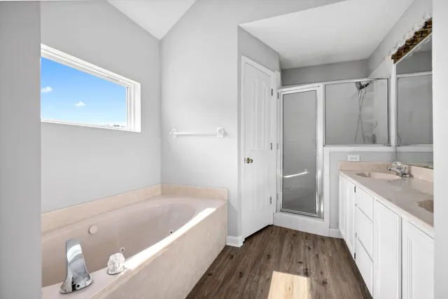 a bathroom with a tub sink and mirror