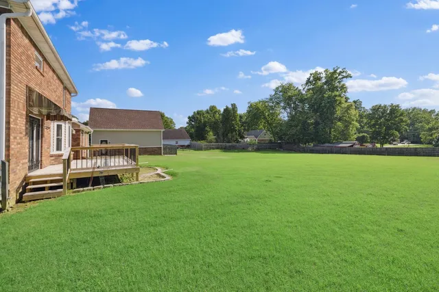 a view of a house with a backyard