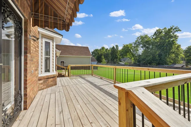 a view of balcony with wooden floor and fence