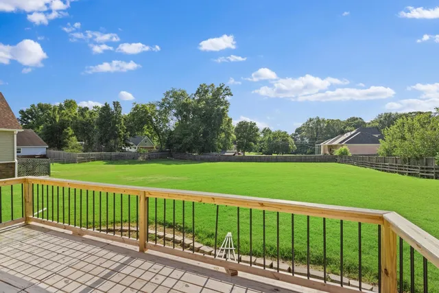 a view of a deck and a yard