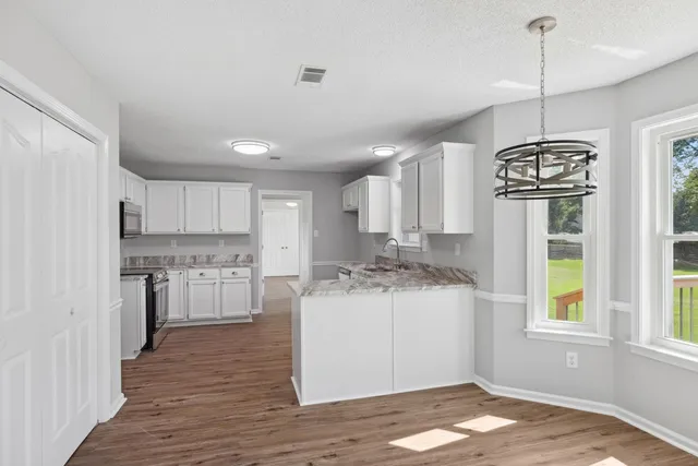 a kitchen with a stove a refrigerator and a sink