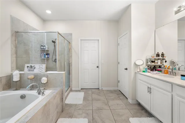 a bathroom with a tub sink and mirror
