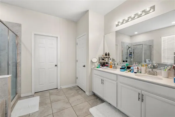 a bathroom with a double vanity sink mirror and