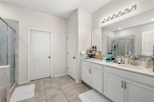 a bathroom with a double vanity sink mirror and
