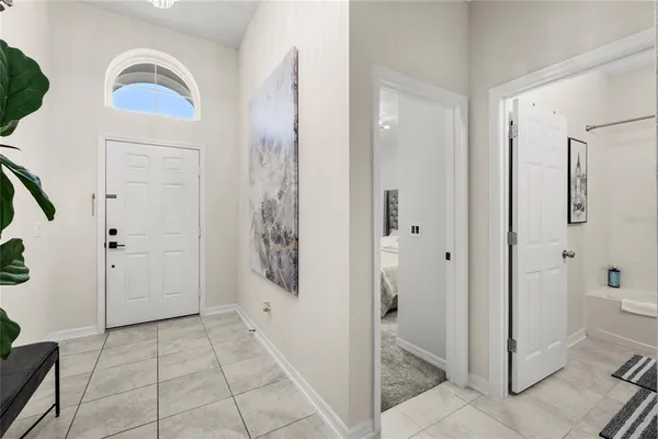 a bedroom with a bed and a ceiling fan