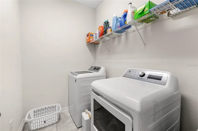 a bedroom with furniture and large windows